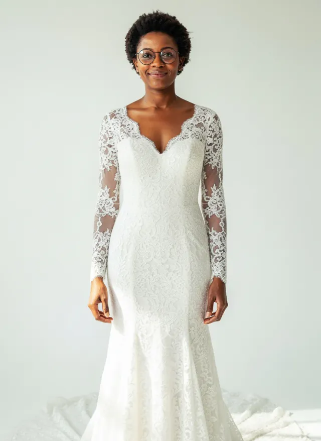 AI-generated preview of a fictional woman in a white lace mermaid wedding gown with long sleeves and a chapel train